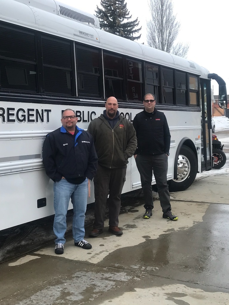 Zach Slayton, Nathan Huether, and Brett Evans from I-State Truck Center with the new activity bus